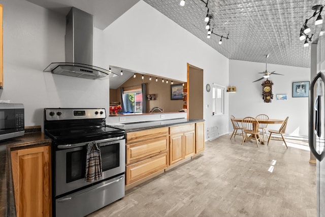 1509 Eagle Dr, Kalispell, MT 59901 - kitchen featuring wall chimney range hood, stainless steel appliances, vaulted ceiling, rail lighting, and a ceiling fan