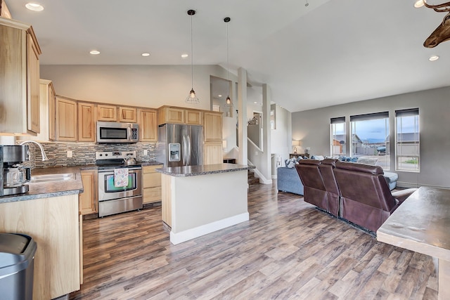 1150 Vega Rd, Helena, MT 59602 - kitchen with appliances with stainless steel finishes, light brown cabinetry, lofted ceiling, open floor plan, and dark wood-style floors