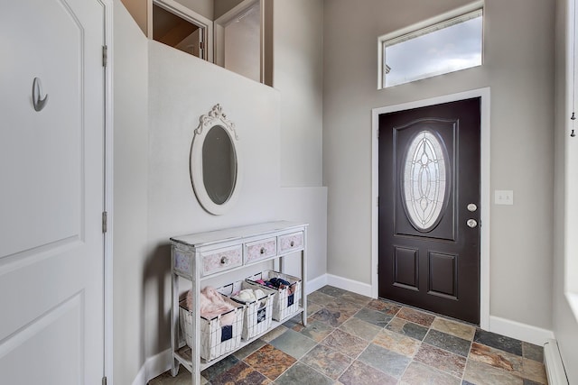 1150 Vega Rd, Helena, MT 59602 - foyer with stone tile flooring, baseboards, and a baseboard radiator
