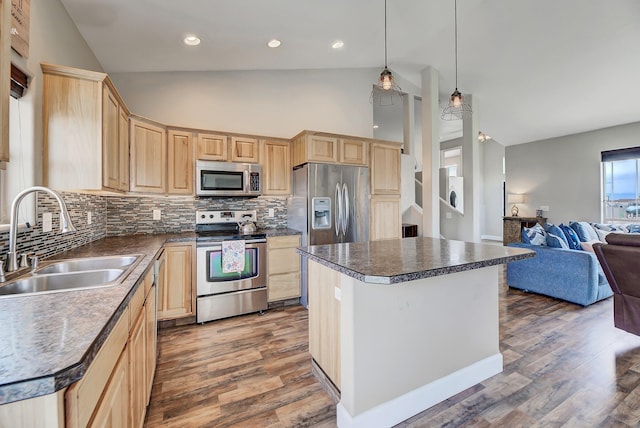 1150 Vega Rd, Helena, MT 59602 - kitchen with light brown cabinets, appliances with stainless steel finishes, a sink, vaulted ceiling, and backsplash