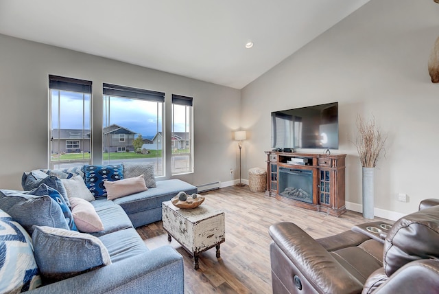 1150 Vega Rd, Helena, MT 59602 - living area featuring baseboards, a baseboard heating unit, wood finished floors, high vaulted ceiling, and a fireplace