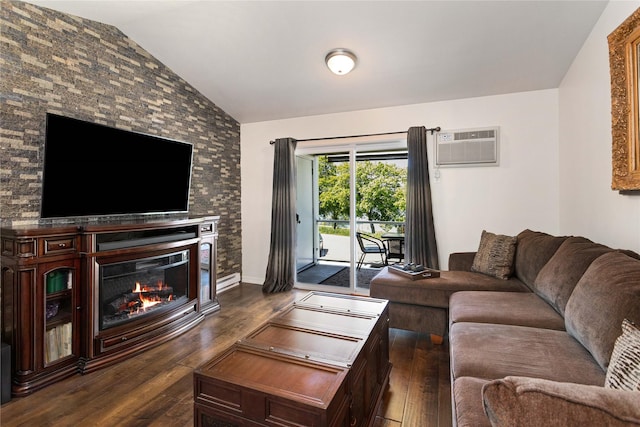 1 Kootenai Ave Unit 17, Polson, MT 59860 - living area featuring vaulted ceiling, a wall unit AC, dark wood-style flooring, and a glass covered fireplace