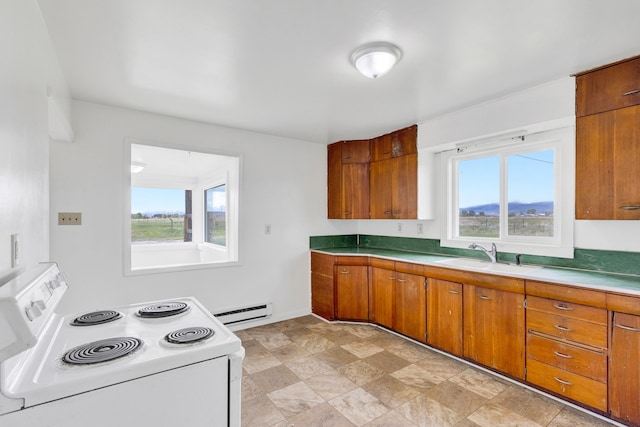 1680 W River Rd, Deer Lodge, MT 59722 - kitchen with white electric stove, a baseboard radiator, plenty of natural light, and brown cabinets