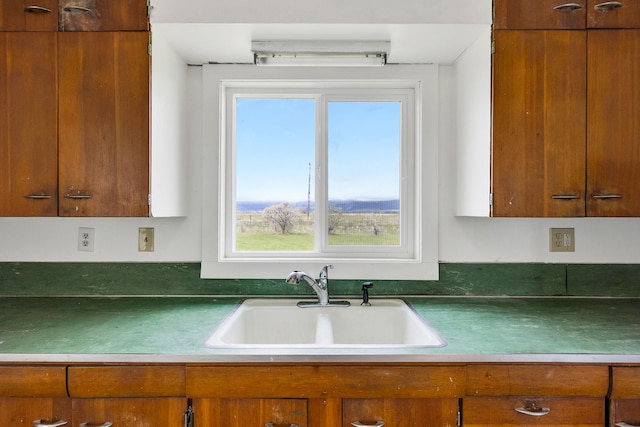 1680 W River Rd, Deer Lodge, MT 59722 - kitchen featuring brown cabinets and healthy amount of natural light