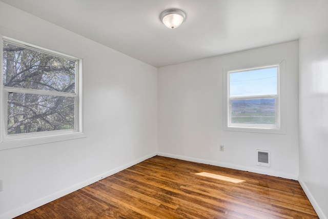 1680 W River Rd, Deer Lodge, MT 59722 - empty room featuring wood finished floors and heating unit