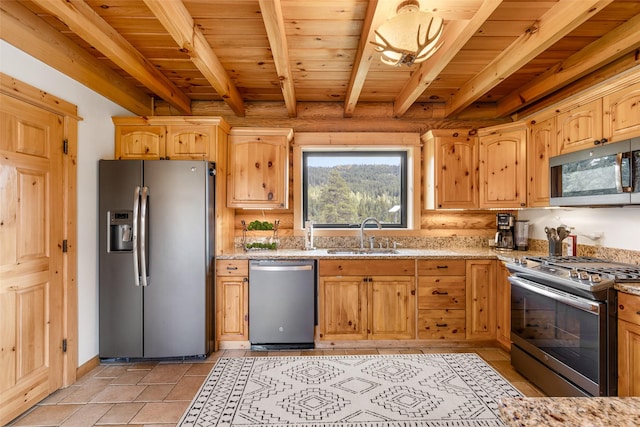 1266 Ousel Falls Rd, Big Sky, MT 59716 - kitchen featuring stainless steel appliances, a sink, light stone countertops, light brown cabinetry, and wooden ceiling with exposed beams