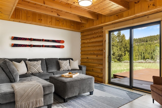 1266 Ousel Falls Rd, Big Sky, MT 59716 - living room featuring rustic walls, wooden ceiling with exposed beams, wood finished floors, and a forest view