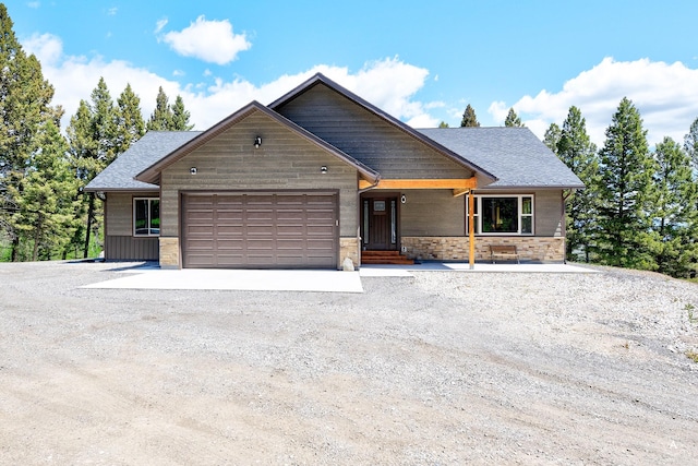 115 Grassy Mountain Rd, White Sulphur Springs, MT 59645 - chalet / cabin with a garage, gravel driveway, stone siding, and roof with shingles