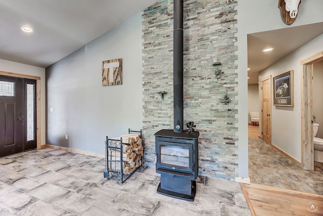 115 Grassy Mountain Rd, White Sulphur Springs, MT 59645 - entryway featuring baseboards, a wood stove, lofted ceiling, and recessed lighting