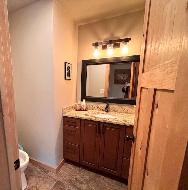 115 Grassy Mountain Rd, White Sulphur Springs, MT 59645 - bathroom featuring vanity, toilet, and baseboards