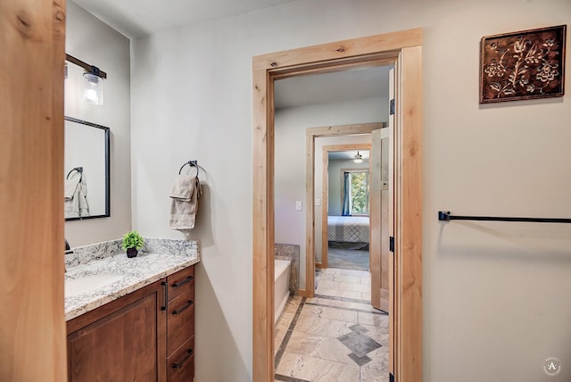 115 Grassy Mountain Rd, White Sulphur Springs, MT 59645 - ensuite bathroom featuring vanity, stone tile flooring, a bathtub, and baseboards