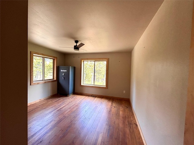 115 Grassy Mountain Rd, White Sulphur Springs, MT 59645 - unfurnished room with hardwood / wood-style floors, baseboards, and a ceiling fan