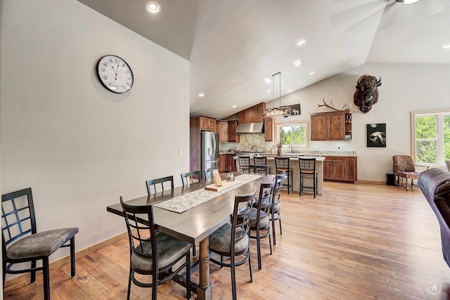 115 Grassy Mountain Rd, White Sulphur Springs, MT 59645 - dining area with light wood-style floors, high vaulted ceiling, recessed lighting, and baseboards