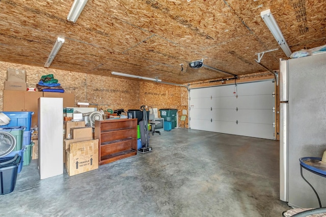 510 Mission St, Stevensville, MT 59870 - garage featuring freestanding refrigerator and a garage door opener