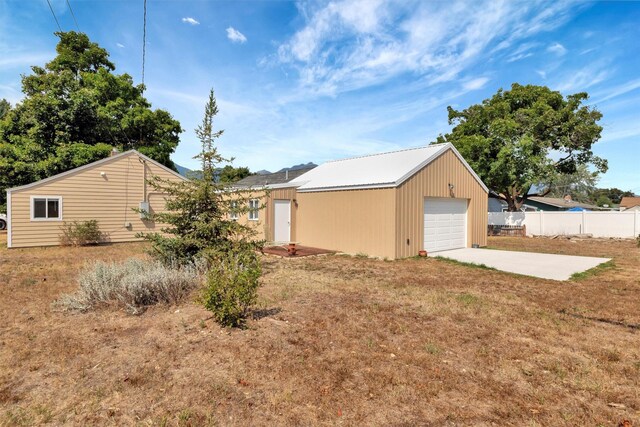 510 Mission St, Stevensville, MT 59870 - view of side of property with concrete driveway, an outbuilding, and a garage