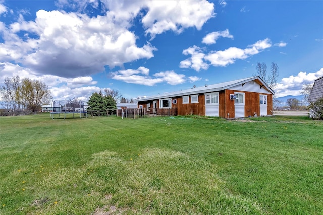 611 Old Corvallis Rd, Corvallis, MT 59828 - view of grassy yard with a trampoline