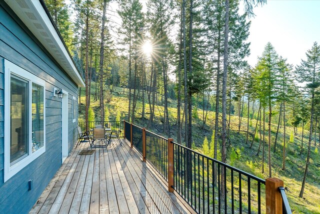 412 Bear Canyon Rd, Lakeside, MT 59922 - wooden deck with outdoor dining space