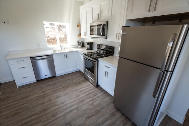 412 Bear Canyon Rd, Lakeside, MT 59922 - kitchen featuring stainless steel appliances, a sink, white cabinetry, dark wood-type flooring, and light countertops