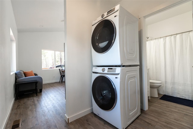 412 Bear Canyon Rd, Lakeside, MT 59922 - laundry room featuring stacked washer / drying machine, hardwood / wood-style floors, and baseboards