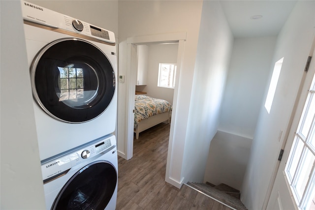412 Bear Canyon Rd, Lakeside, MT 59922 - washroom featuring stacked washer / dryer, wood finished floors, and healthy amount of natural light