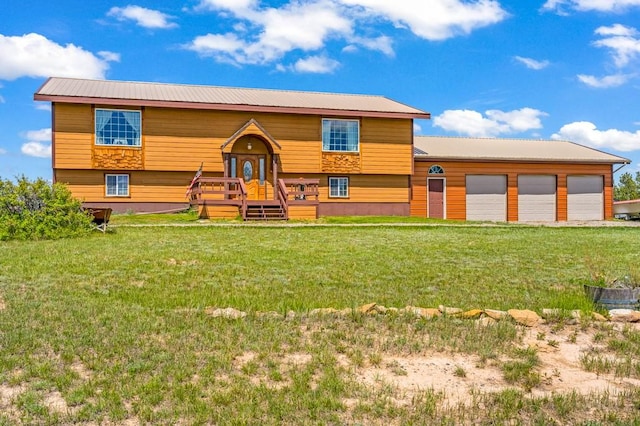 16 Grassland Way, Roundup, MT 59072 - bi-level home with a front yard, metal roof, and a garage