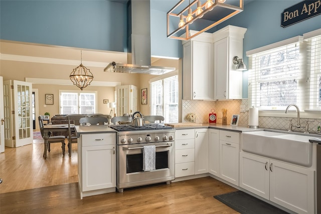 442 4th Ave E, Kalispell, MT 59901 - kitchen with a sink, backsplash, dishwasher, and white cabinetry