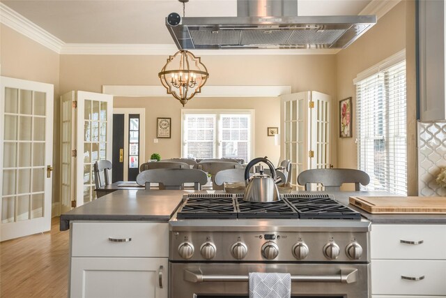 442 4th Ave E, Kalispell, MT 59901 - kitchen with appliances with stainless steel finishes, beverage cooler, backsplash, white cabinets, and light countertops