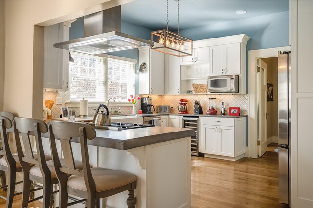 442 4th Ave E, Kalispell, MT 59901 - dining space featuring a chandelier, light wood-style flooring, crown molding, and baseboards