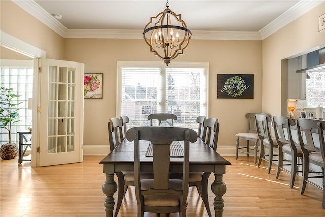 442 4th Ave E, Kalispell, MT 59901 - dining space with radiator heating unit, ornamental molding, a chandelier, baseboards, and light wood finished floors