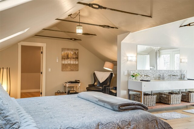 442 4th Ave E, Kalispell, MT 59901 - bedroom with a skylight, lofted ceiling, light wood finished floors, and baseboards