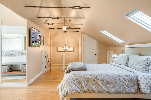 442 4th Ave E, Kalispell, MT 59901 - living area with vaulted ceiling, wood finished floors, baseboards, and a skylight