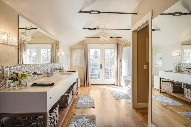 442 4th Ave E, Kalispell, MT 59901 - full bathroom with lofted ceiling, decorative backsplash, vanity, a chandelier, and a shower with curtain