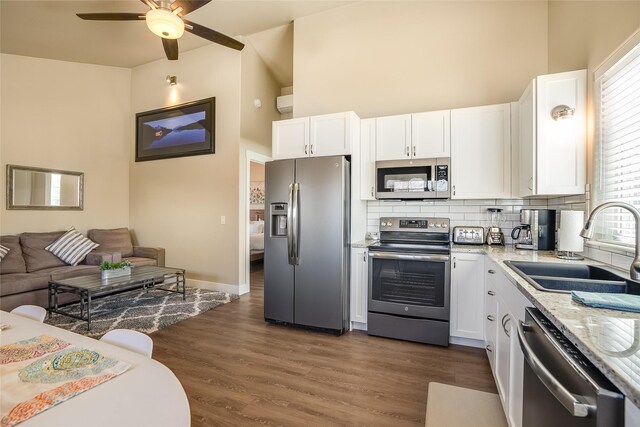 442 4th Ave E, Kalispell, MT 59901 - kitchen featuring appliances with stainless steel finishes, white cabinetry, tasteful backsplash, and a sink