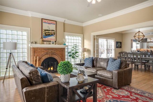 442 4th Ave E, Kalispell, MT 59901 - living room with ceiling fan, a chandelier, ornamental molding, and light wood-type flooring