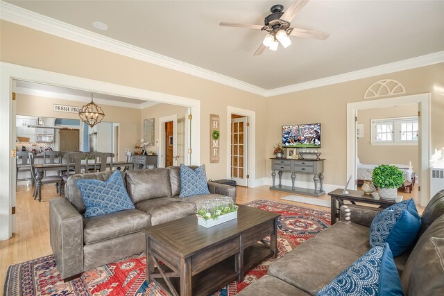 442 4th Ave E, Kalispell, MT 59901 - living room featuring ornamental molding, light wood-style flooring, a ceiling fan, and baseboards