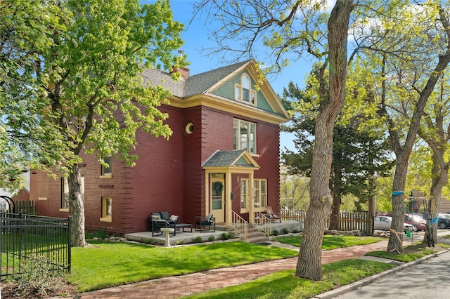 318 Power St, Helena, MT 59601 - view of front of house featuring brick siding, a chimney, and a patio area