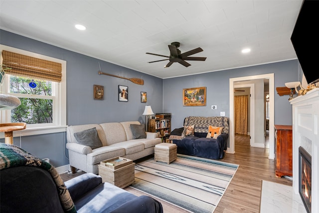 2115 Burlington Ave, Missoula, MT 59801 - living area featuring a fireplace with flush hearth, ceiling fan, light wood-style floors, baseboards, and recessed lighting