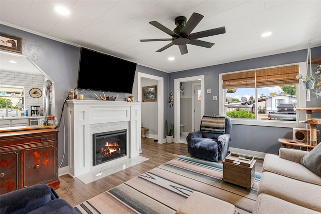 2115 Burlington Ave, Missoula, MT 59801 - living room with ceiling fan, a fireplace with flush hearth, wood finished floors, recessed lighting, and ornamental molding