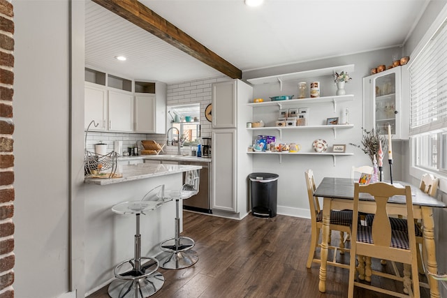 2115 Burlington Ave, Missoula, MT 59801 - kitchen with healthy amount of natural light, dark wood finished floors, a sink, tasteful backsplash, and beamed ceiling