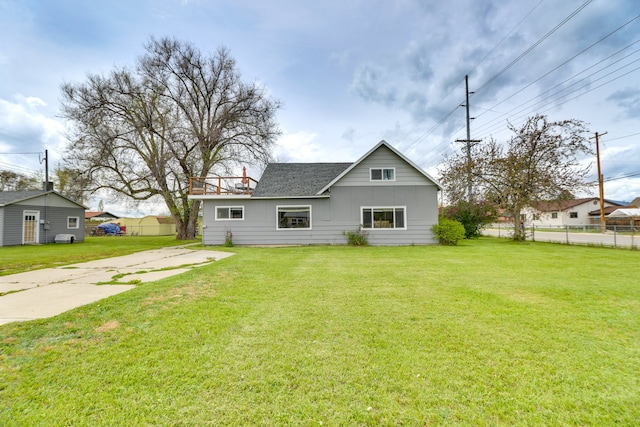 503 7th Ave W, Polson, MT 59860 - back of house with concrete driveway and board and batten siding