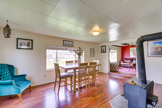 503 7th Ave W, Polson, MT 59860 - dining space with a wood stove, wood finished floors, and baseboards