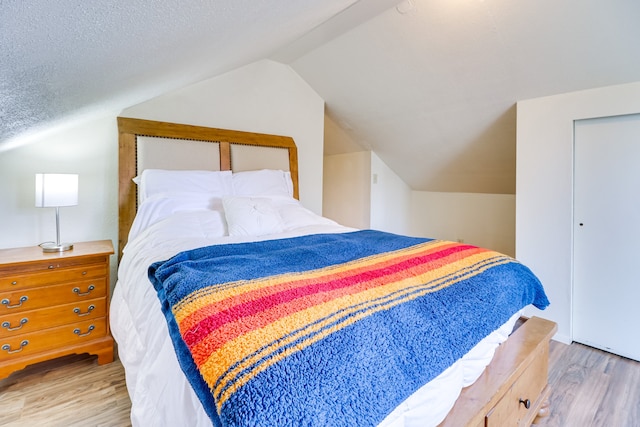 503 7th Ave W, Polson, MT 59860 - bedroom featuring wood finished floors and lofted ceiling
