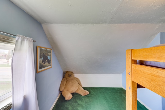 503 7th Ave W, Polson, MT 59860 - unfurnished bedroom featuring lofted ceiling, carpet floors, and baseboards