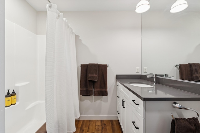 100 Woodlands Way Unit S305, Kalispell, MT 59901 - full bath with vanity, a shower with shower curtain, and wood finished floors