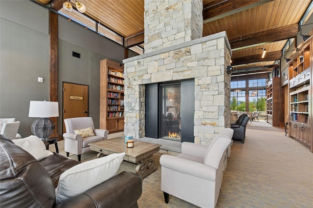 100 Woodlands Way Unit S305, Kalispell, MT 59901 - living room with a wood ceiling with exposed beams, a towering ceiling, a fireplace, and carpet floors