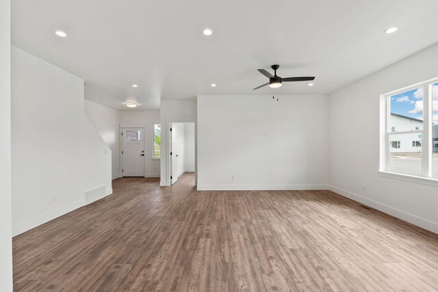 602 Holstein Way, Kalispell, MT 59901 - unfurnished living room featuring plenty of natural light, wood finished floors, recessed lighting, and ceiling fan