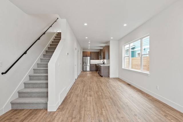 604 Holstein Way, Kalispell, MT 59901 - unfurnished living room with light wood-style floors, recessed lighting, and stairway