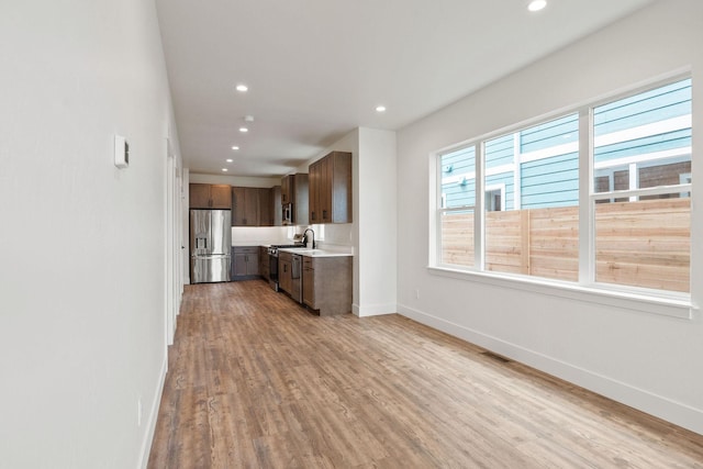 604 Holstein Way, Kalispell, MT 59901 - kitchen featuring stainless steel fridge, range, light countertops, recessed lighting, and light wood-type flooring