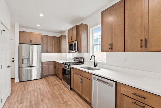 604 Holstein Way, Kalispell, MT 59901 - kitchen featuring appliances with stainless steel finishes, light wood finished floors, recessed lighting, and brown cabinets