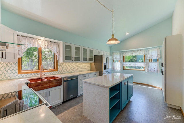2685 Pinkerton Dr, East Helena, MT 59635 - kitchen featuring appliances with stainless steel finishes, a sink, decorative backsplash, plenty of natural light, and vaulted ceiling